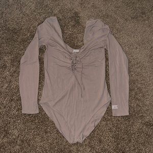 Victoria’s Secret cream colored body suit, tie up front with straps